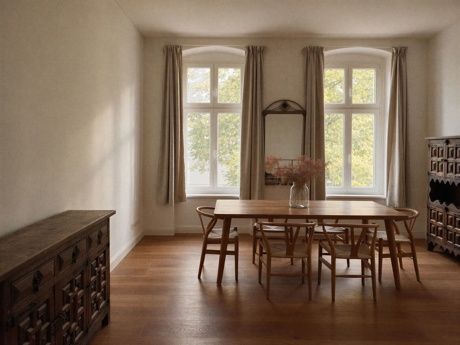 Dining room with two tall windows and a wooden dining table